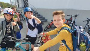 Chłopcy przy rowerach przed szkołą