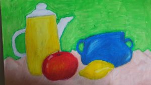 Praca przedstawia zestaw brył (od lewej): żółty dzbanek, jabłuszko, cytrynkę i na drugim planie niebieską miseczkę.