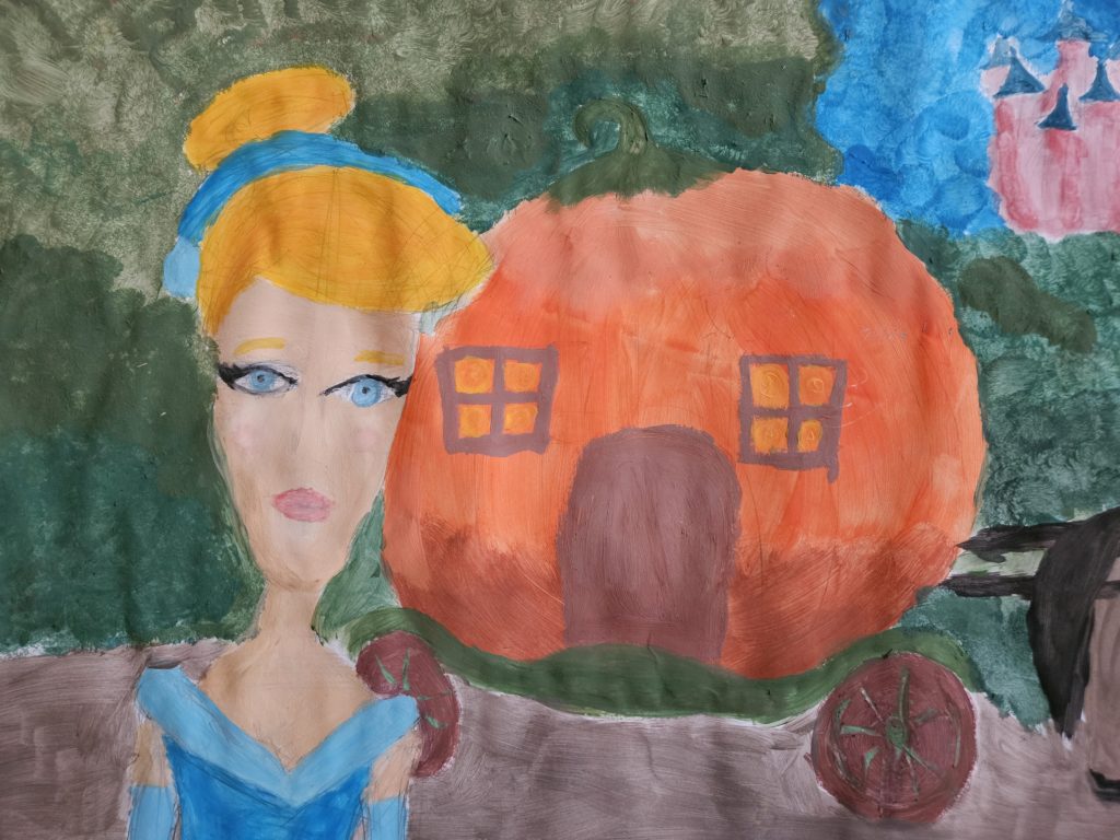Praca przedstawia na pierwszym planie „kopciuszka” w niebieskiej sukni, a za nim kareta o kształcie pomarańczowej dyni. W tle zielony las