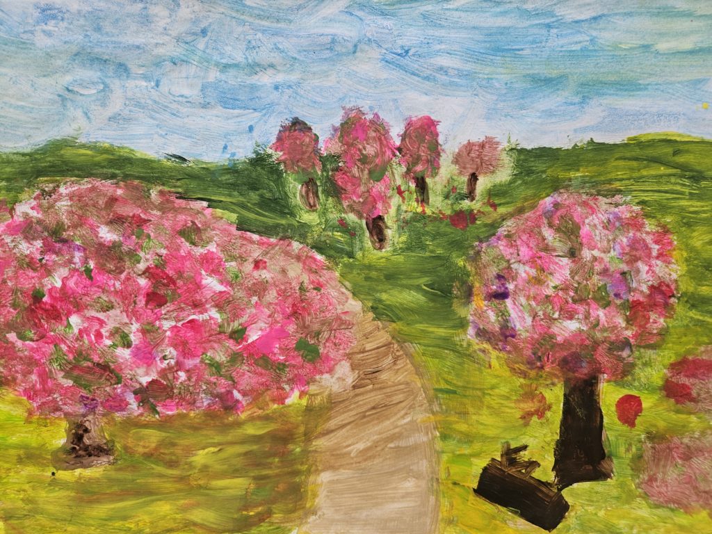 Na pierwszym planie kwitnące drzewka oraz na ostatnim