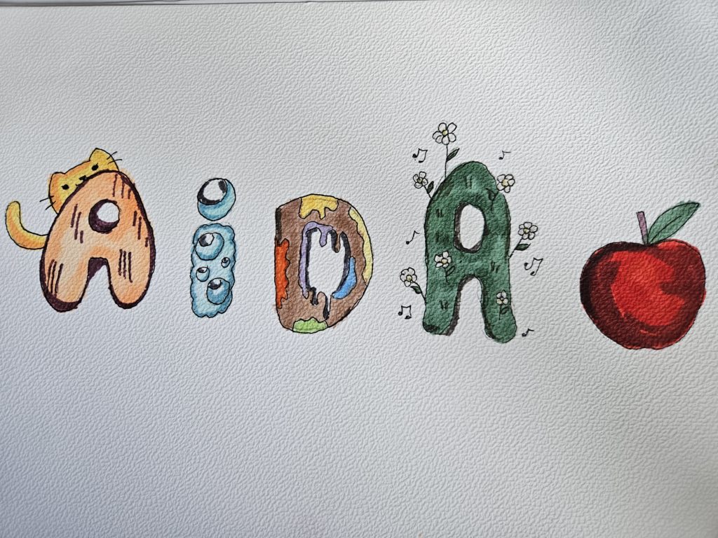 Na pracy wielokolorowe, ozdobne słowo "Aida"