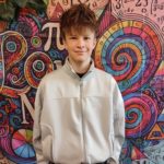 Portret Ignacego Jakubowskiego, laureata matematycznego, na tle kolorowych spiral i symboli naukowych. 